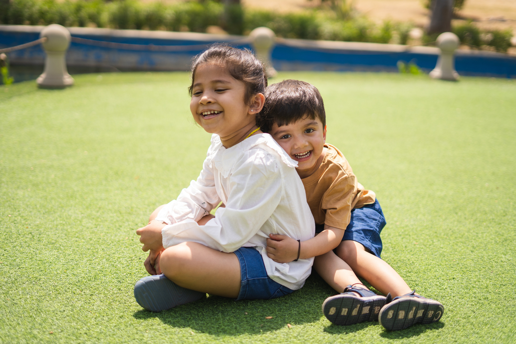 Little Siblings Embracing Each Other Outdoors